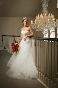 Bride with Flowers Leaning on Railing